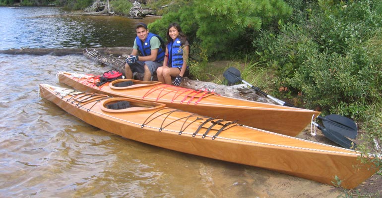 A couple with their Chesapeake 16  and Chesapeake 14 wooden kayaks.
