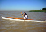 A woman paddling a Chesapeake 16 wooden kayak built by Pablo S. on the Rio Del La Plata in Argentina Thumbnail
