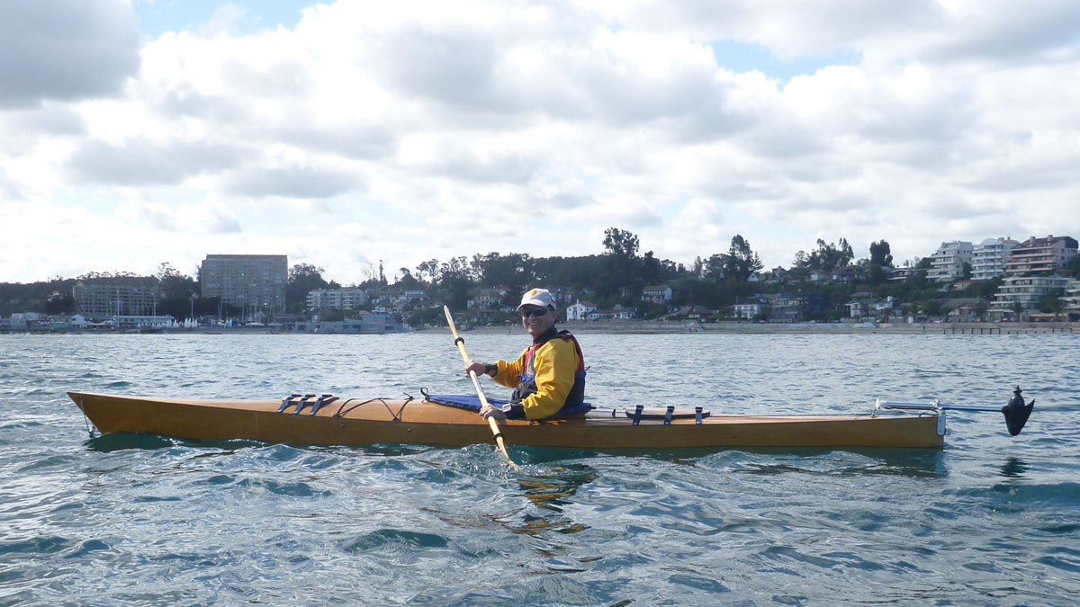Arturo K. paddling his Chesapeake 16 wooden kayak with an electric trolling motor at the stern in Algarrobo Bay, Chile