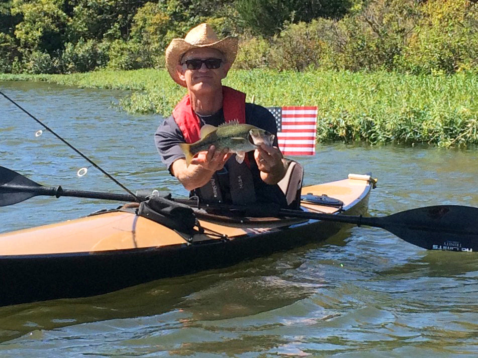 Nick B. in Oklahoma showing off a fish he caught from his Chesapeake 16 wooden kayak
