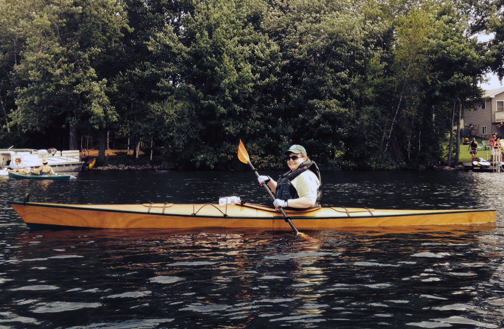 Nora G. paddling her Chesapeake 16 wooden kayak