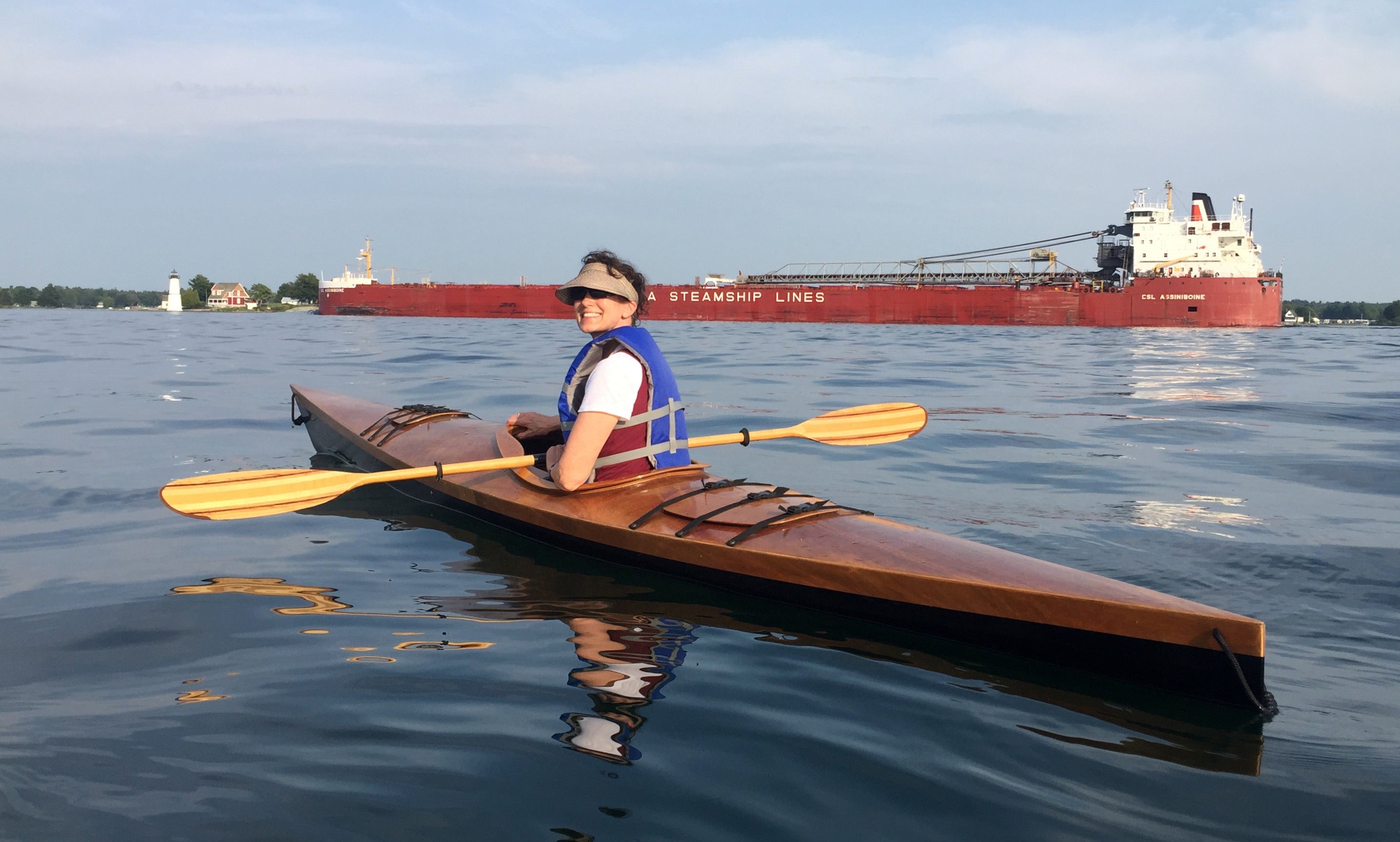 Kathleen C paddling on the St. Lawrence River in her Chesapeake 16 wooden kayak built by her husband, Timothy.