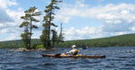Paddling a Chesapeake 17LT built by Joe F. past a rocky islet Thumbnail