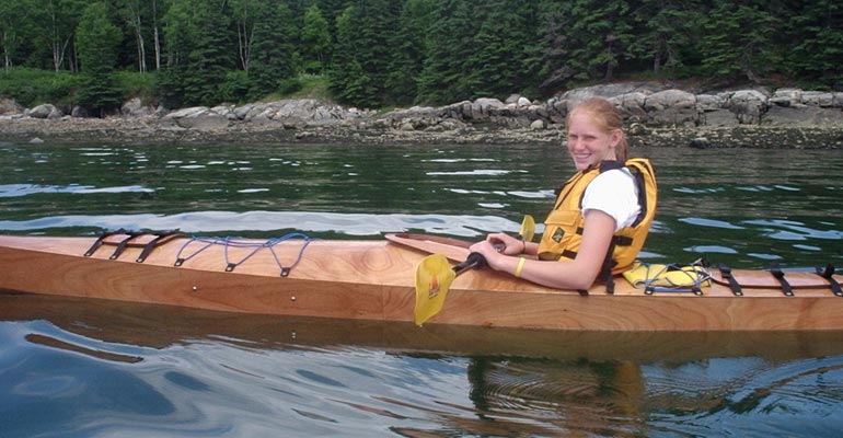 A young paddler enjoying a Chesapeake 17LT wooden kayak built by Marty H