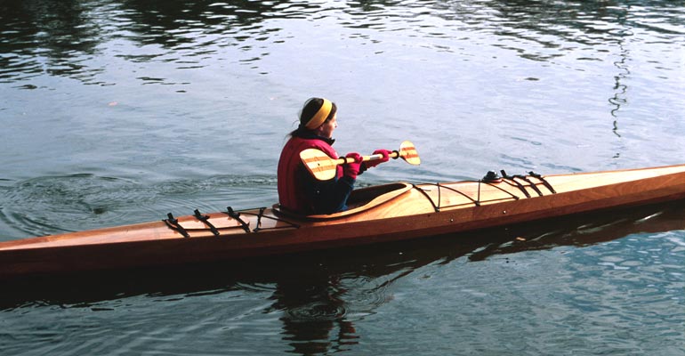  A woman paddling a Chesapeake 17LT wooden kayak