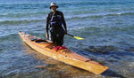 George T. grinning at the water's edge with his Chesapeake 17LT wooden kayak Thumbnail