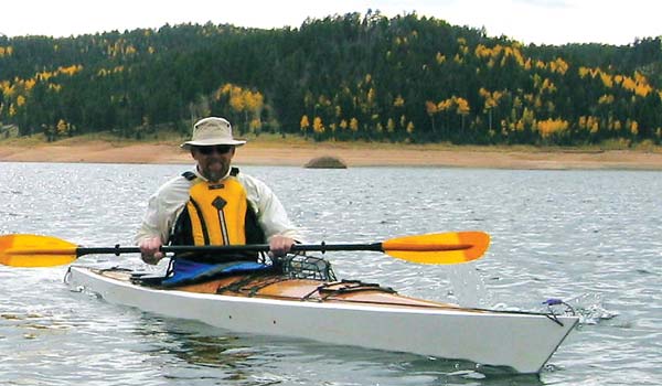 A man enjoying a paddle in a Chesapeake 17LT wooden kayak