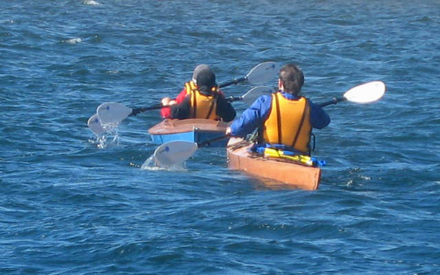 Paddling a Chesapeake 17LT wooden kayak built by Steven L. behind a couple paddling a Mill Creek 16.5 wooden kayak