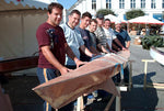 Teamwork! A group of young men and their coach with a Chesapeake 17LT wooden kayak in the final stages of construction Thumbnail