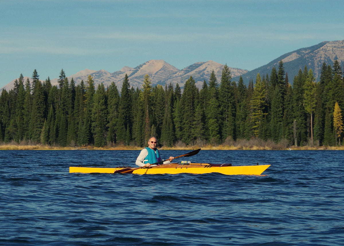 David S. paddling his Chesapeake 17LT wooden kayak on a mountain lake in Montana