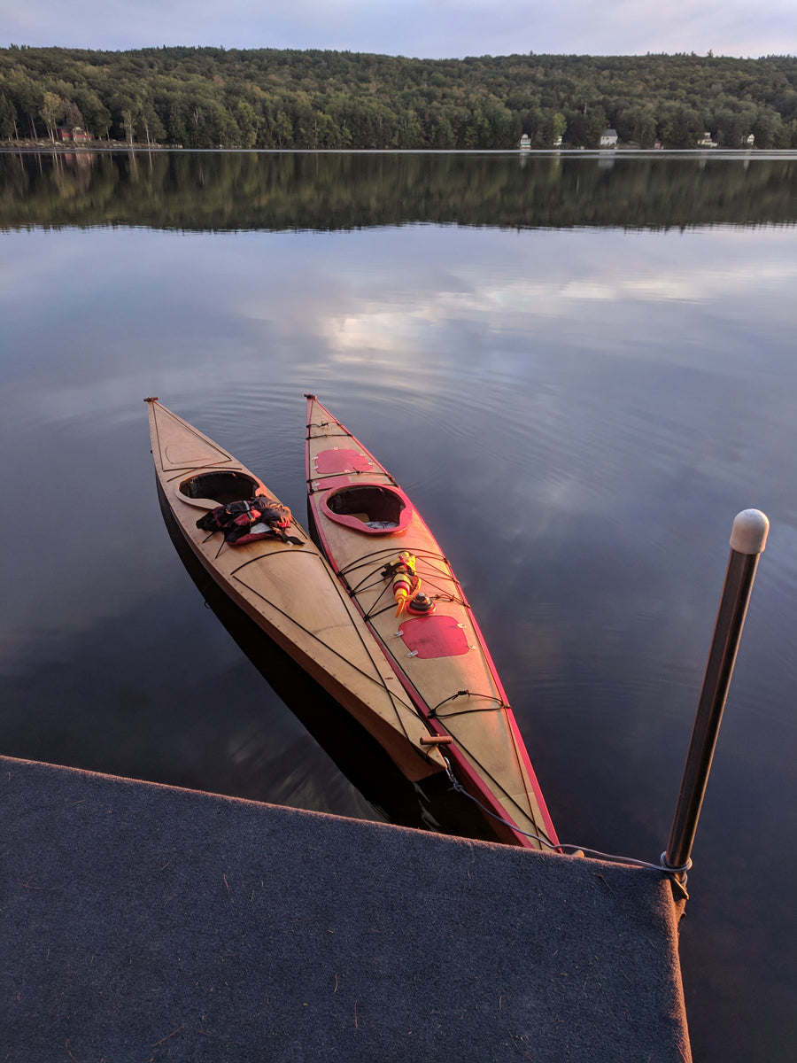 Chesapeake 16LT and 17LT wooden kayaks built by Edward B. floating on Lake Skatatuke, New Hampshire
