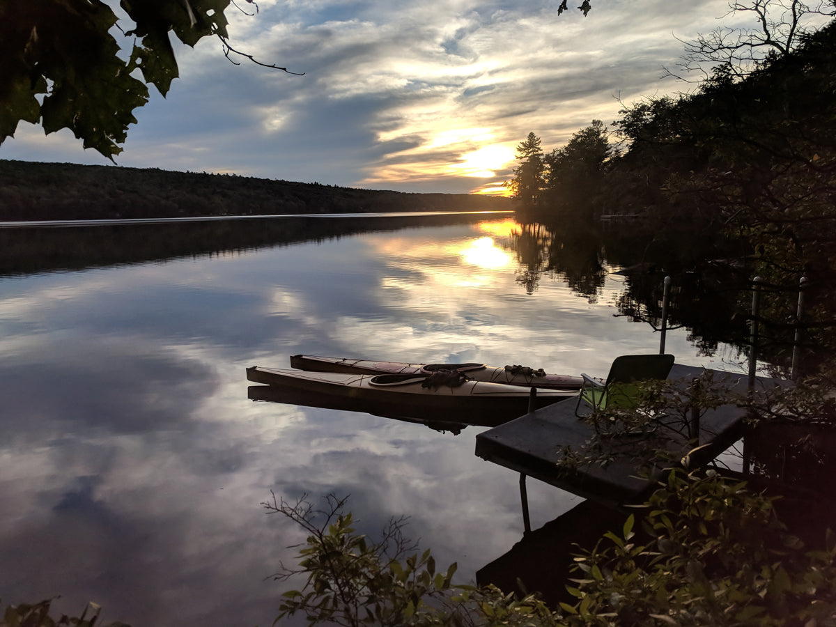 A sunset view over Lake Skatatuke, NH, of Chesapeake 17LT and 16LT wooden kayaks