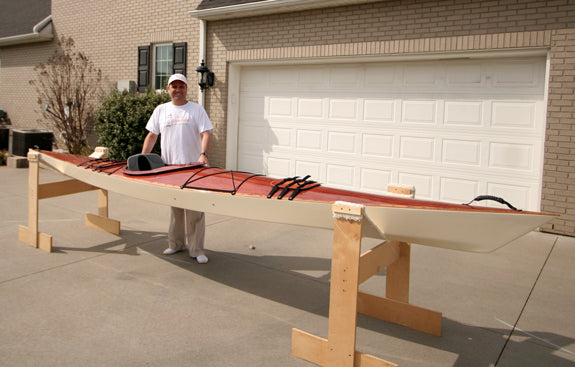 Andy W. shows off his newly finished Chesapeake 17LT wooden kayak in the driveway before launch day