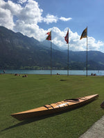 Hans O.'s Chesapeake 17LT wooden kayak on a lakeside lawn in Switzerland Thumbnail