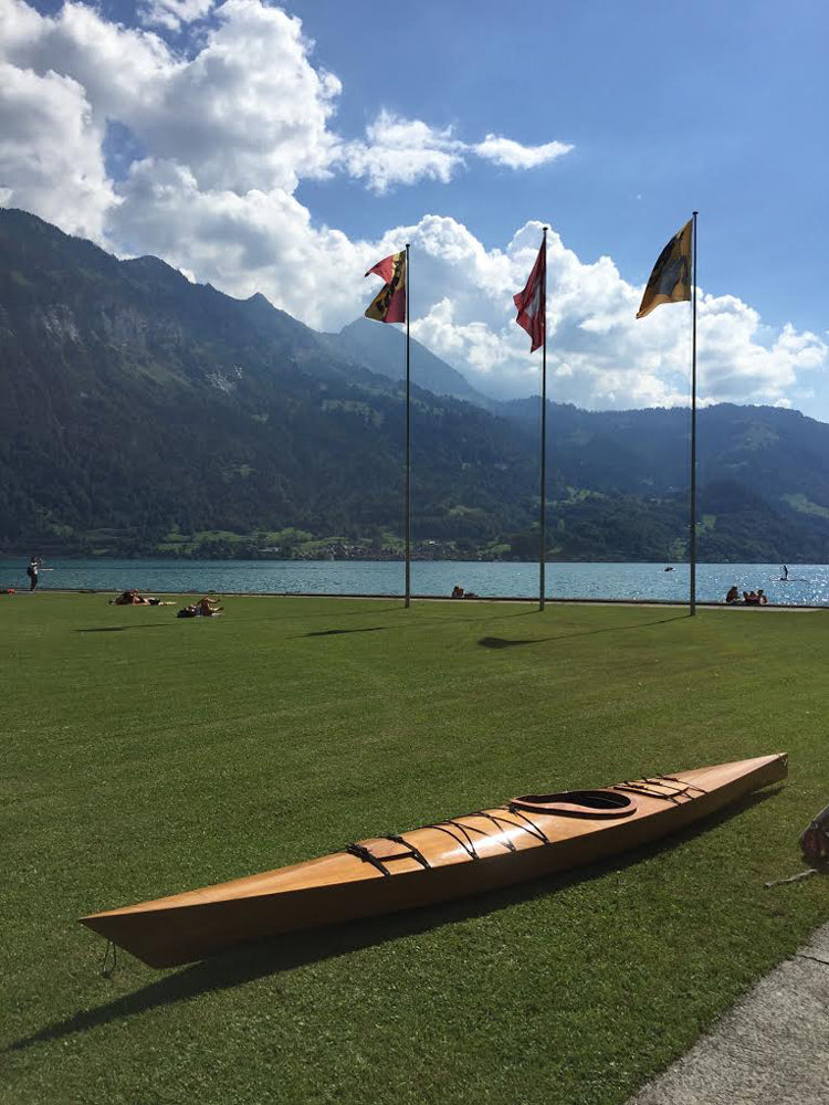 Hans O.'s Chesapeake 17LT wooden kayak on a lakeside lawn in Switzerland