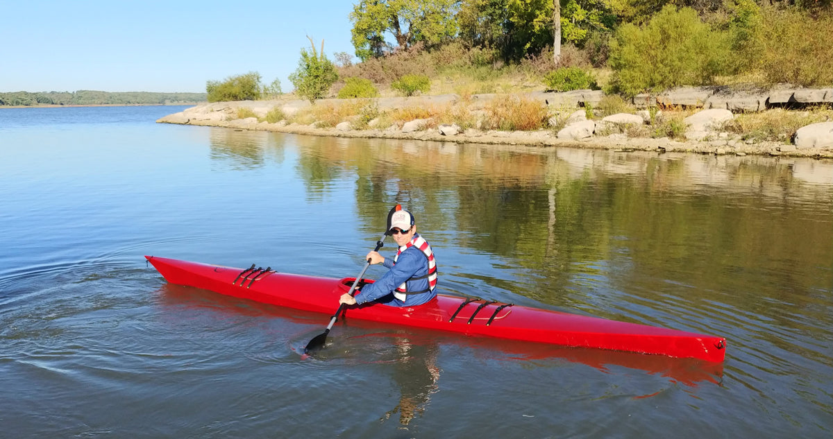Paddling a bright red  Chesapeake 17LT wooden kayak built by Keith G.