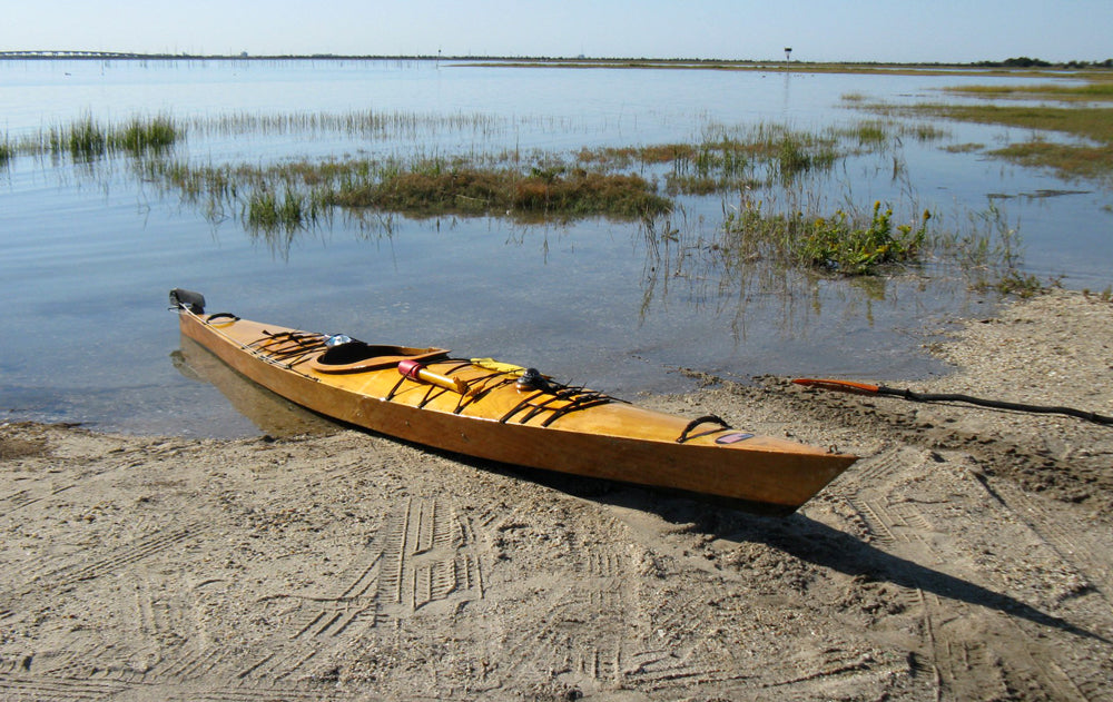 A beached Chesapeake 17LT wooden kayak built by Ray M.