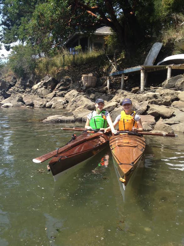 Young paddlers enjoying a day on the water in a pair of Chesapeake 17LT wooden kayaks build by Reade J. in Victoria, BC