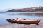 A Chesapeake 17LT wooden kayak built by Kyle H. beached at a mountain lake Thumbnail
