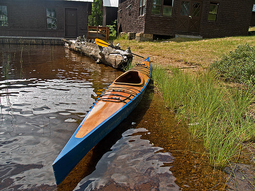 A Chesapeake 17 wooden kayak built by Tom O. at the water's edge