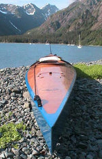 A Chesapeake 17 wooden kayak at the edge of the fjord Thumbnail