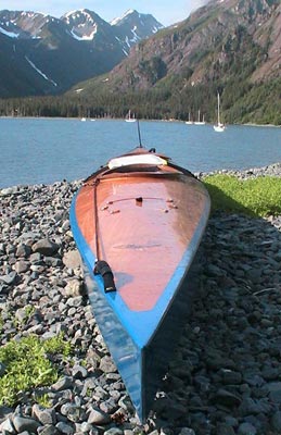 A Chesapeake 17 wooden kayak at the edge of the fjord