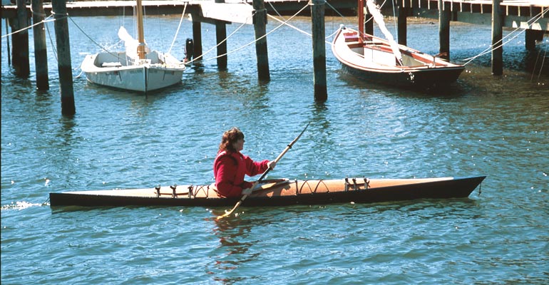 Paddling a Chesapeake 17 wooden kayak past a marina
