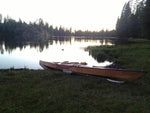 A Chesapeake 17 wooden kayak built by Greg G. pulled up on the grassy bank of Rucker Lake in California Thumbnail