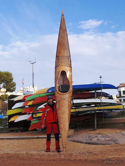 Johan V.  holding his Chesapeake 17 wooden kayak on end in a marina
