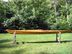 A Chesapeake 17 wooden kayak built by Steven T. on stands in a yard Thumbnail