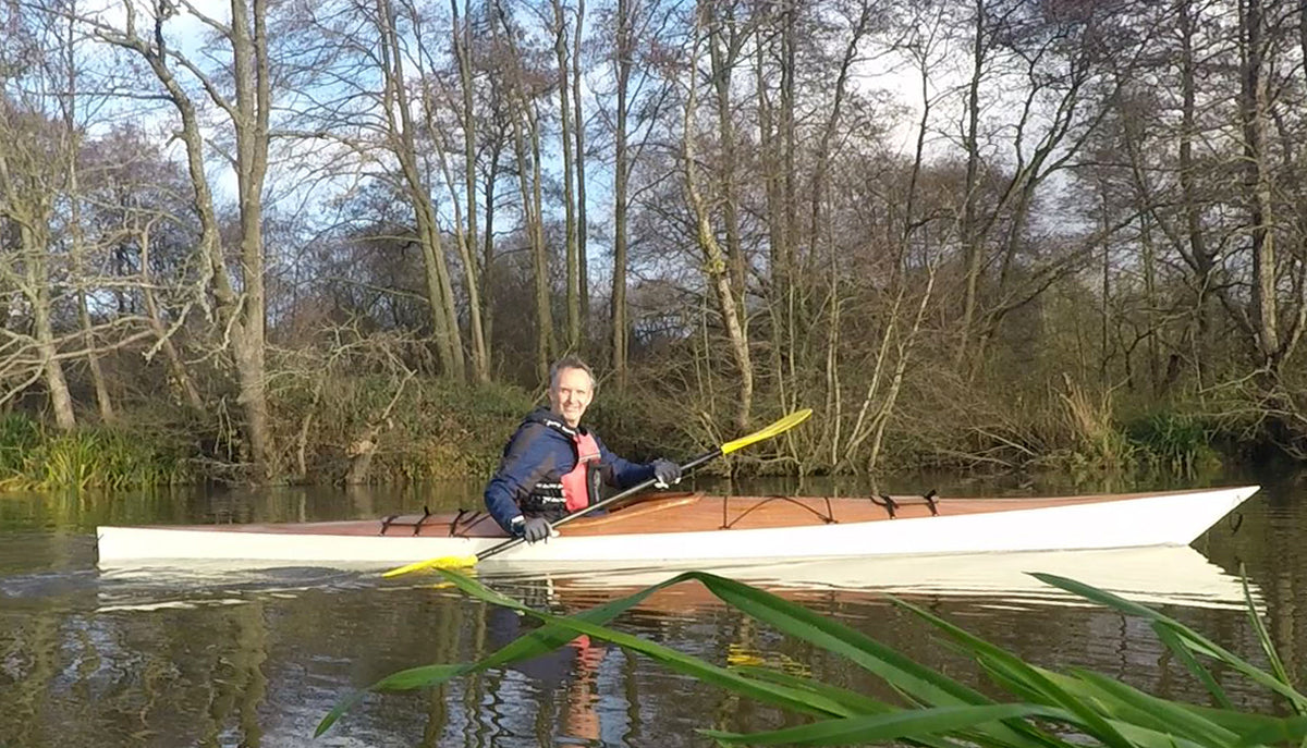 A man paddling a Chesapeake 17 wooden kayak built by Phil H. in the English Lake District