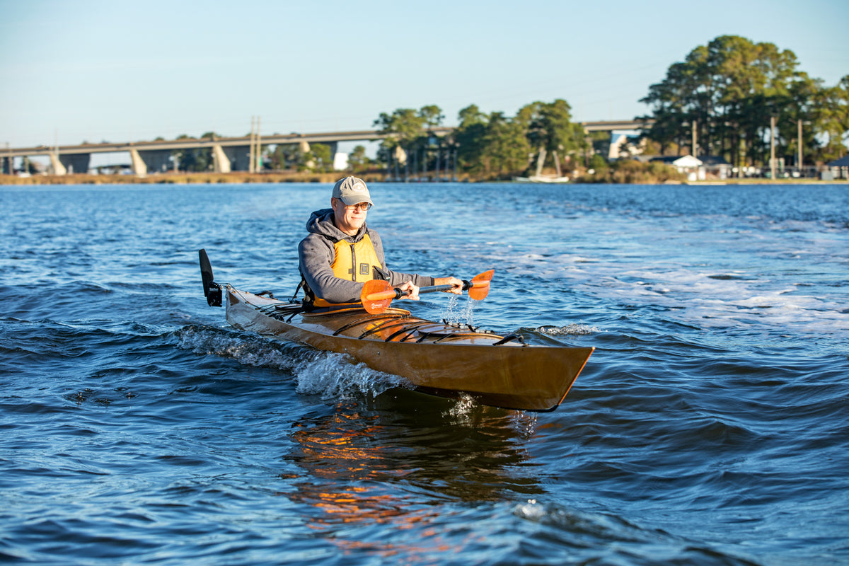 A man paddling a Chesapeake 17 wooden kayak at Kent Narrows on the Chesapeake Bay