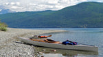 A Chesapeake 17 wooden kayak near a Chesapeake 16LT, both built by Harrison B., on a stony beach at McDonald Lake in Montana's Glacier National Park Thumbnail