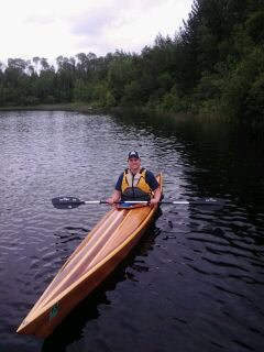 Paddling a Chesapeake 17 hybrid wooden kayak with strip-patterned deck, built by Tom G.