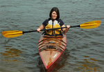 A woman paddling a Chesapeake 17 wooden kayak Thumbnail