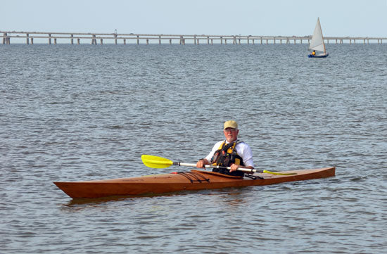 A man  paddling a Chesapeake 18 wooden kayak at OkoumeFest 2012
