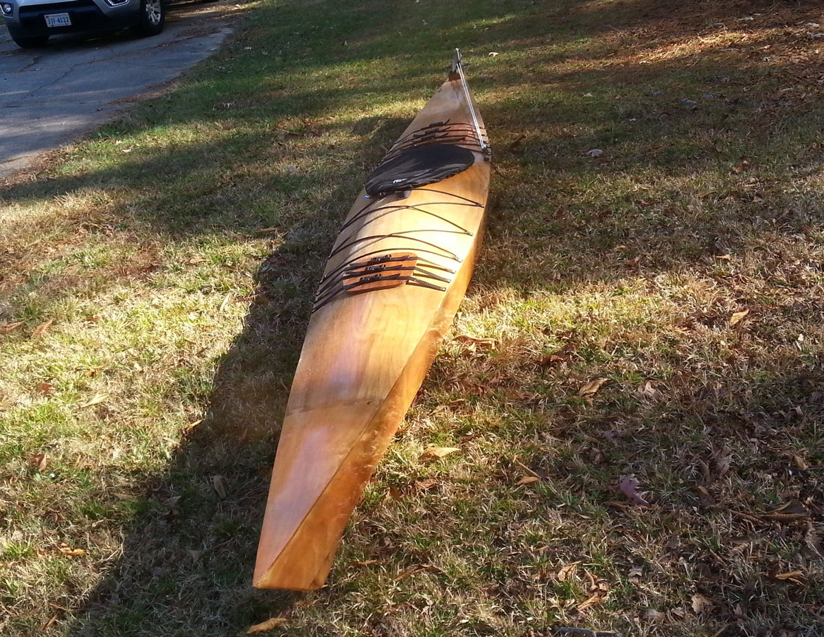 A Chesapeake 18 wooden kayak built by John O. on the lawn