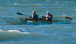 A couple paddling a Chesapeake Double wooden kayak in rough water Thumbnail