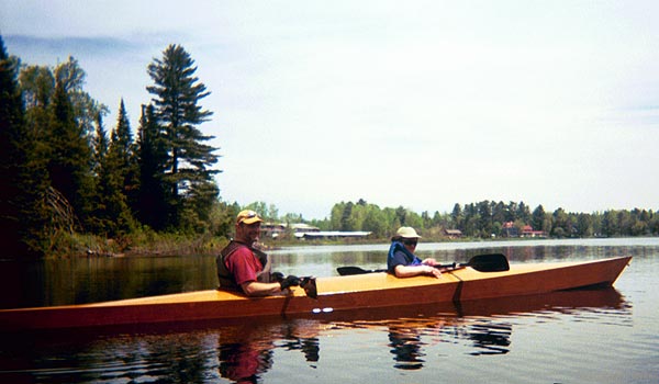 A couple of paddlers enjoying a Chesapeake Double wooden kayak built by John H.