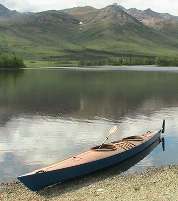 A Chesapeake Double wooden kayak beached on the shore of Otto Lake