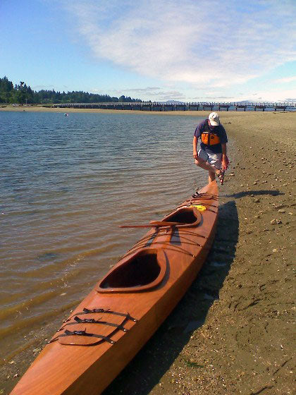 David R. preparing to launch his Chesapeake Double wooden kayak from a beach in the Steamboat Islands