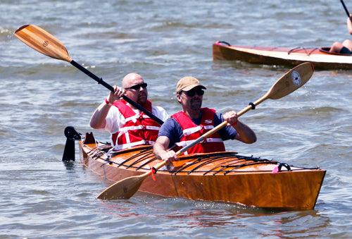 Two men paddling a Chesapeake Double wooden kayak during OkoumeFest 2010