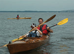 A couple enjoying a test paddle in a Chesapeake Double wooden kayak at OkoueFest 2009 Thumbnail