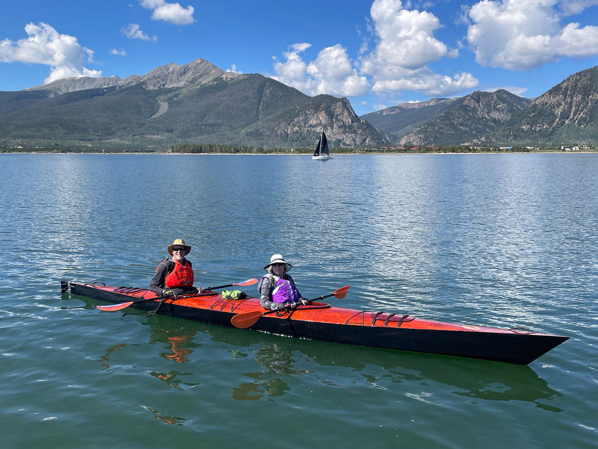 Brian and Katherine P. paddling their Chesapeake Double wooden kayak on Colorado's Lake Dillon