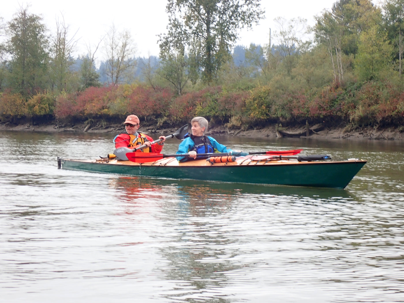 A couple paddling a Chesapeake Double wooden kayak built by Sam M. on the Snohomish River near Seattle