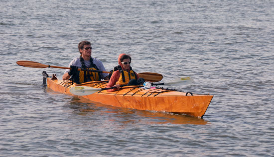 A couple trying the fit of a Chesapeake Double wooden kayak at OkoumeFest 2012