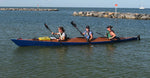 The team of three paddlers heading for the beach in a Chesapeake Triple wooden kayak bulit by Jason R. Thumbnail