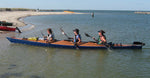 Three paddlers reaching the shore in a Chesapeake Triple wooden kayak built by Jason R. Thumbnail