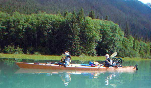 A couple paddling a loaded Chesapeake Triple wooden kayak built by Mike K.