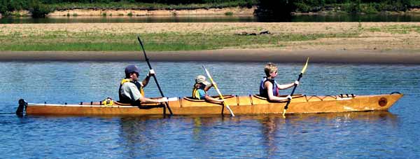 A family paddle in a Chesapeake Triple wooden kayak built by Jim B.